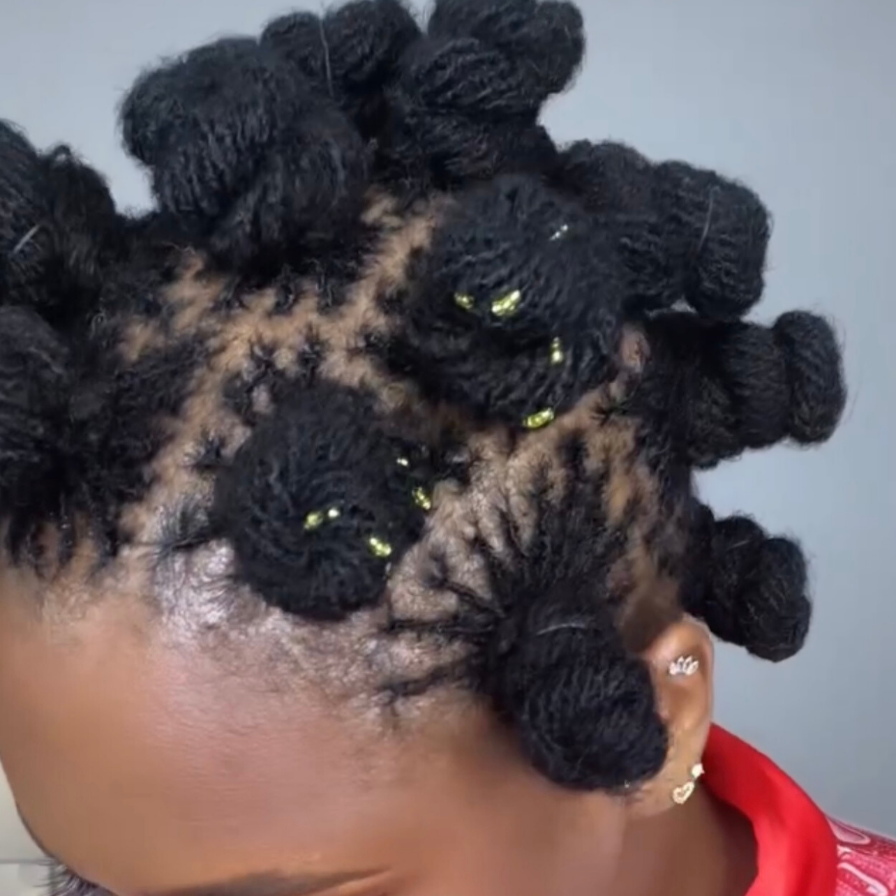 woman with microlocs and bantu knots