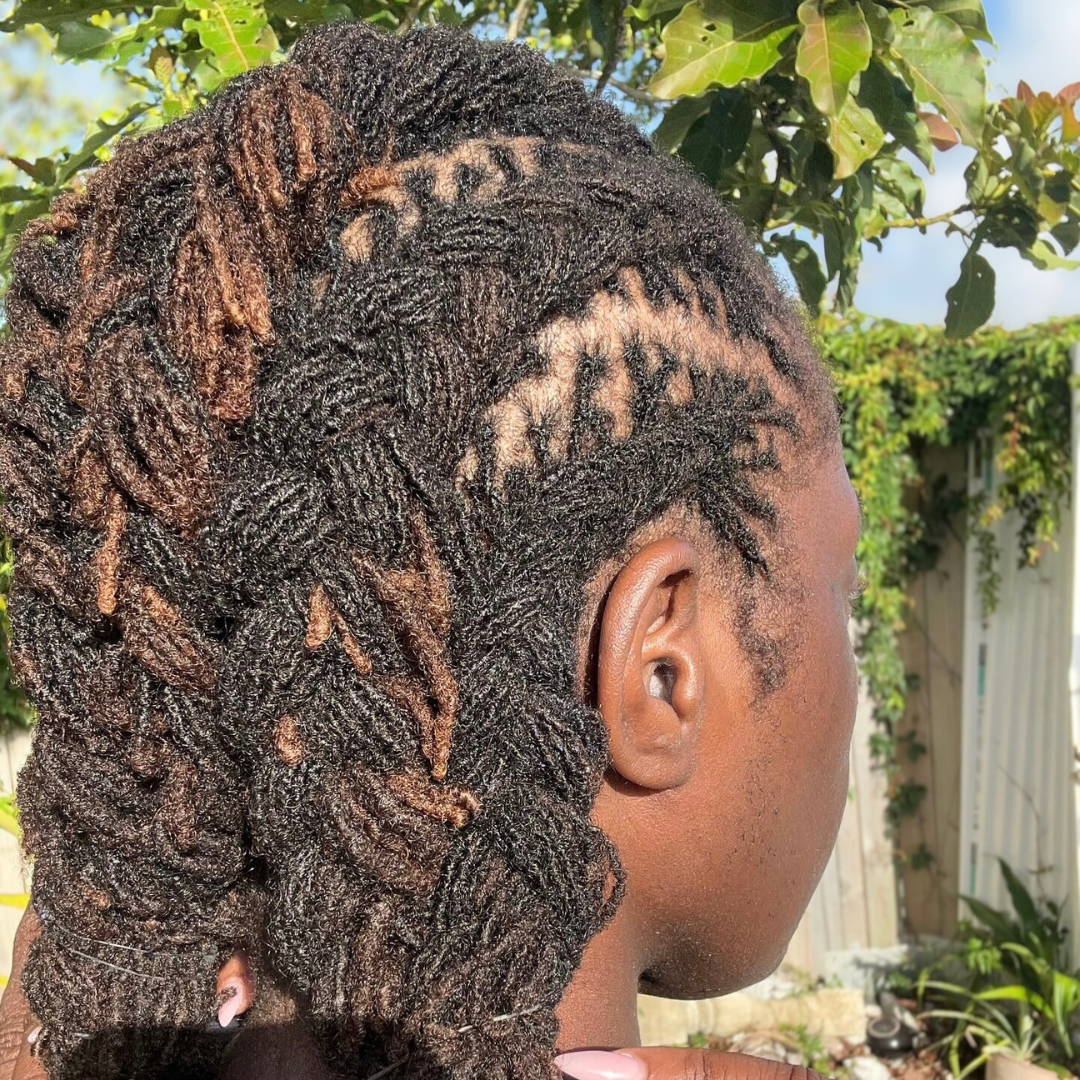 woman with microlocs and cornrow braids