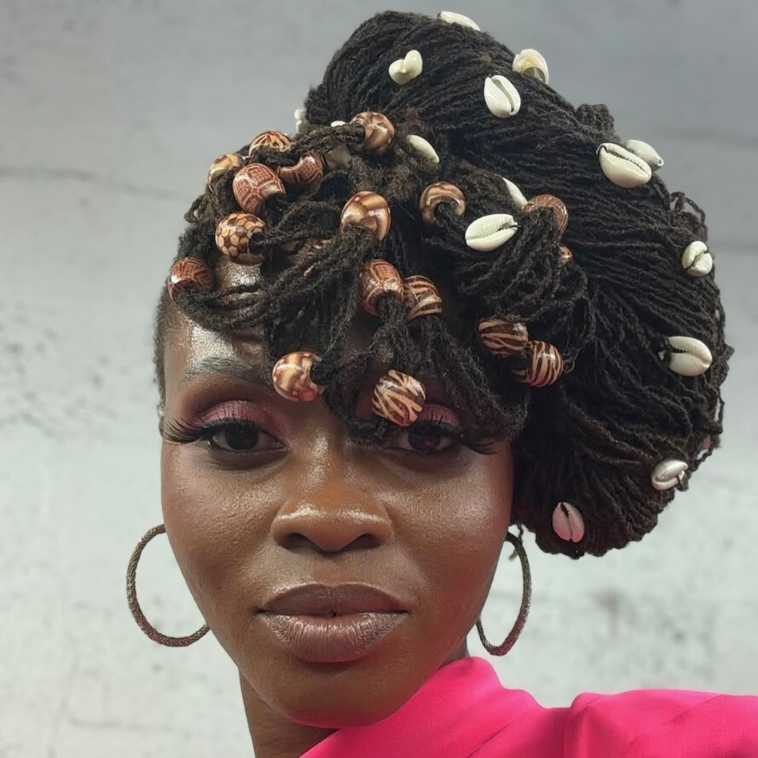 woman with microlocs and beaded twised updo