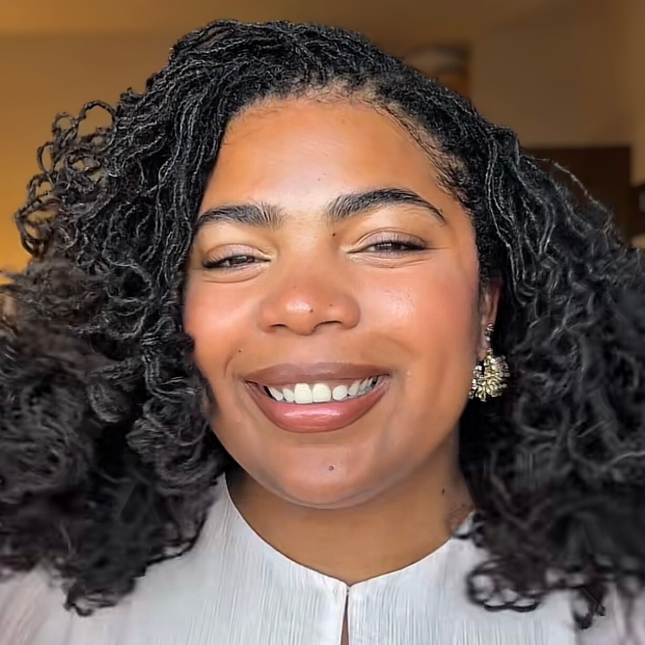 woman with microlocs and bantu knot curls