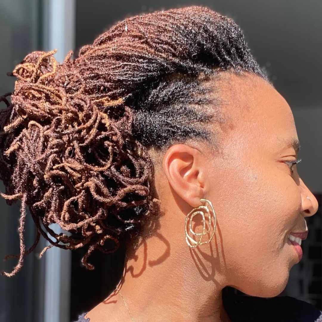 woman with microlocs and french twist ponytail updo