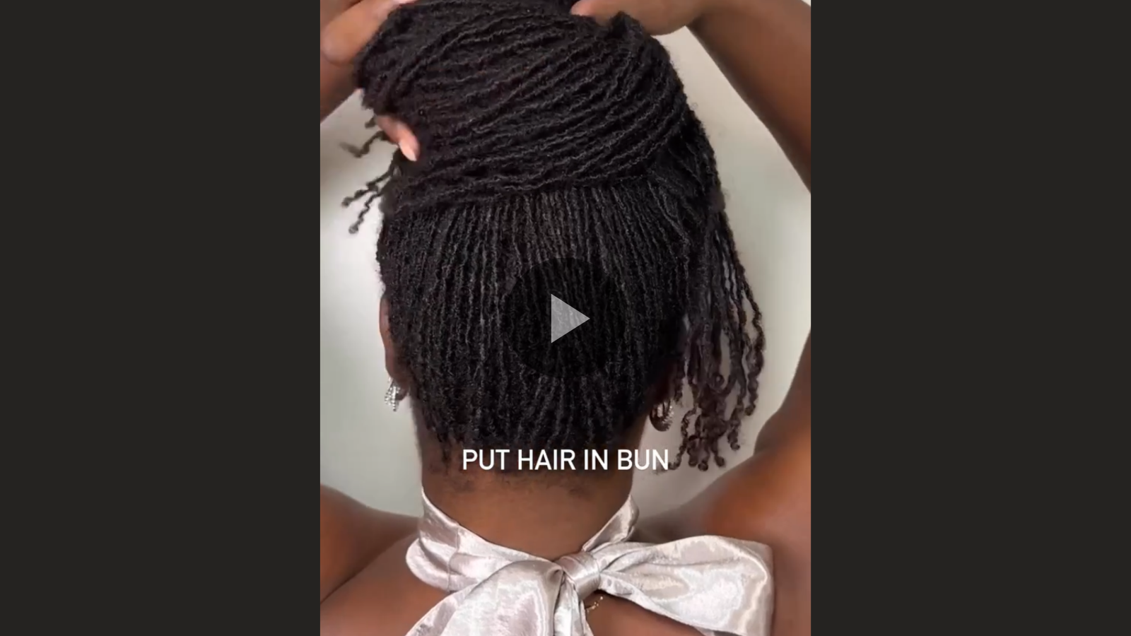 woman with microlocs and bun and bangs