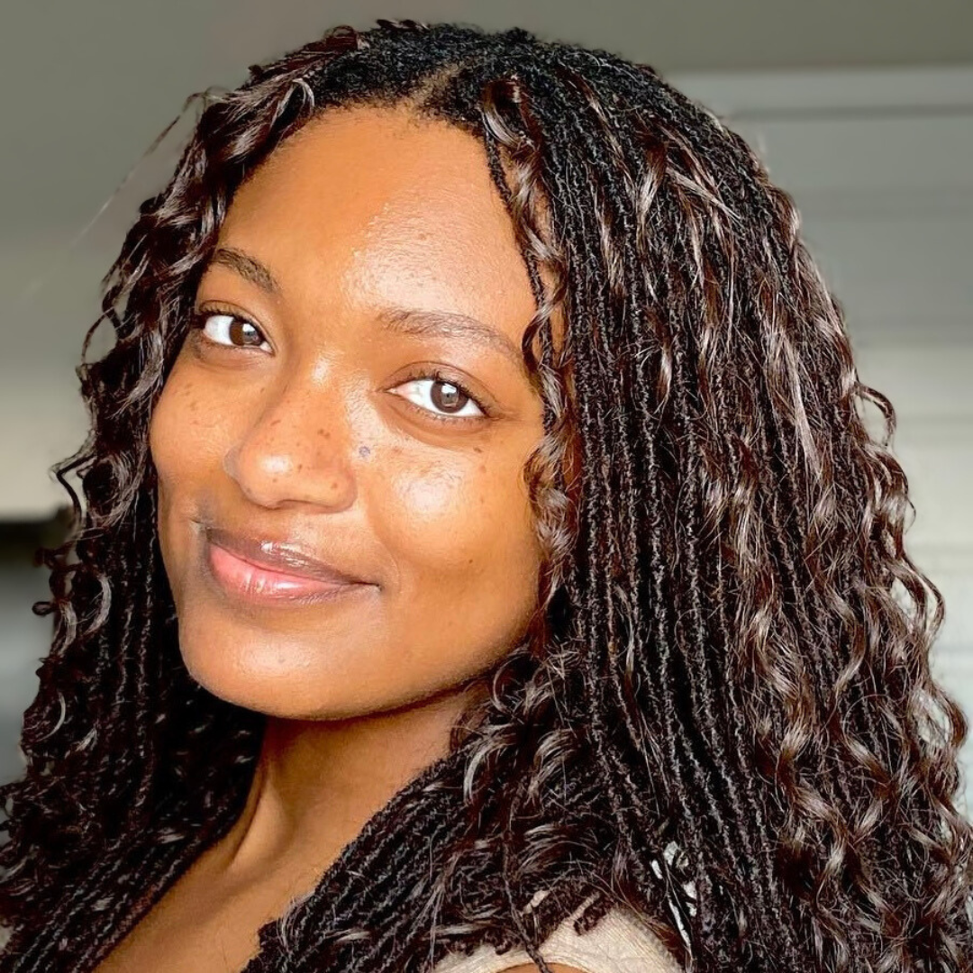 woma with microlocs and boho extensions