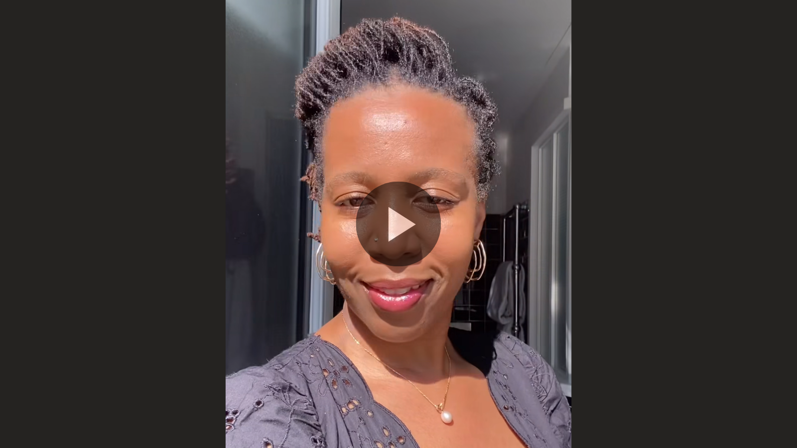 woman with microlocs and french roll crown