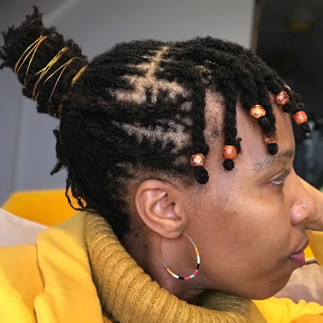 woman with microlocs and twisted twine updo