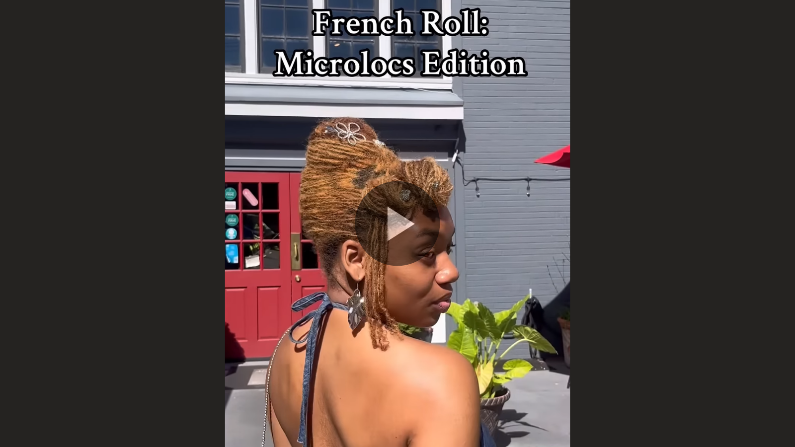 woman with microlocs and french roll and jewels