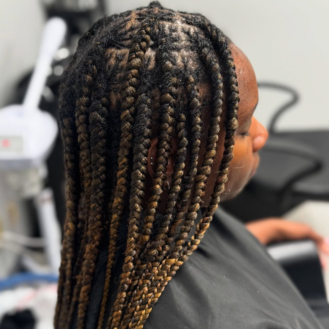 woman with box braids over microlocs