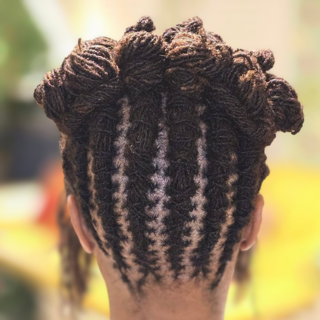 woman with microlocs and twisted bantu knot up updo