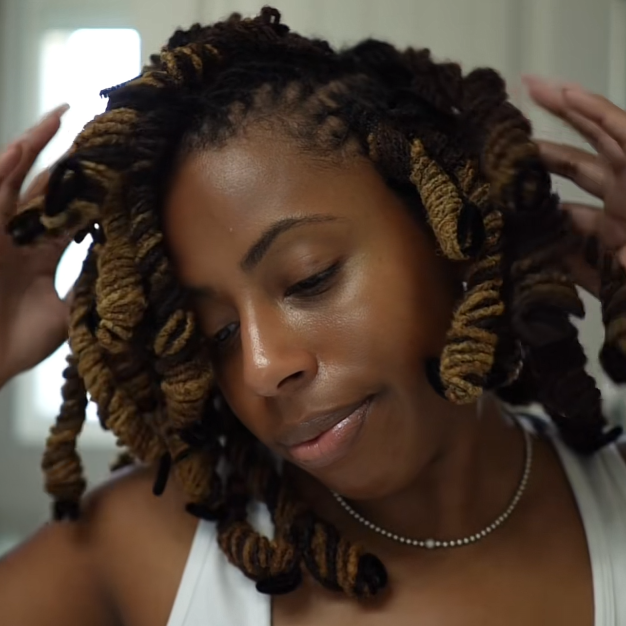 woman with microlocs and pipe cleaner curls