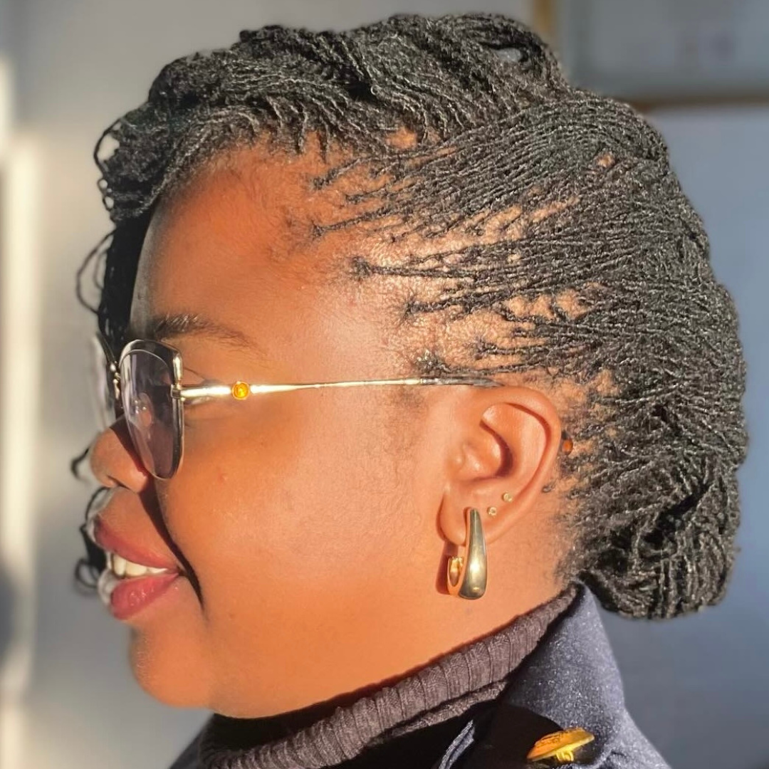 woman with microlocs and side french braid with bangs