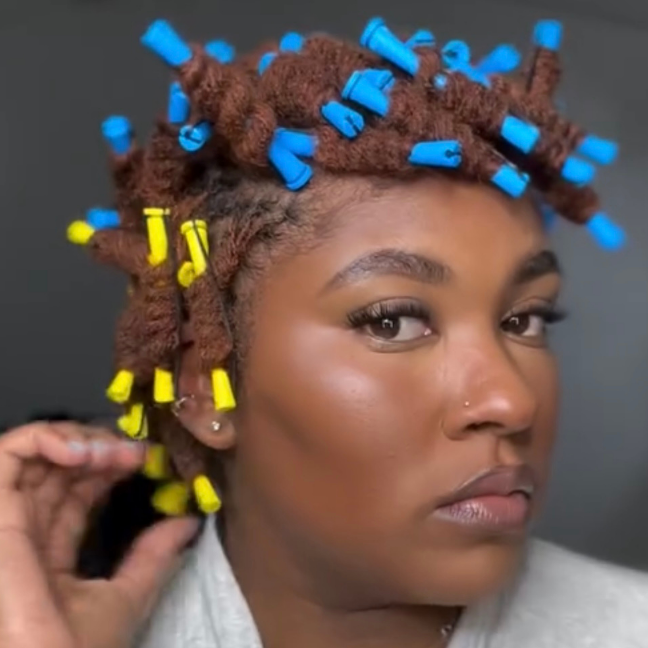 woman with microlocs and perm rods