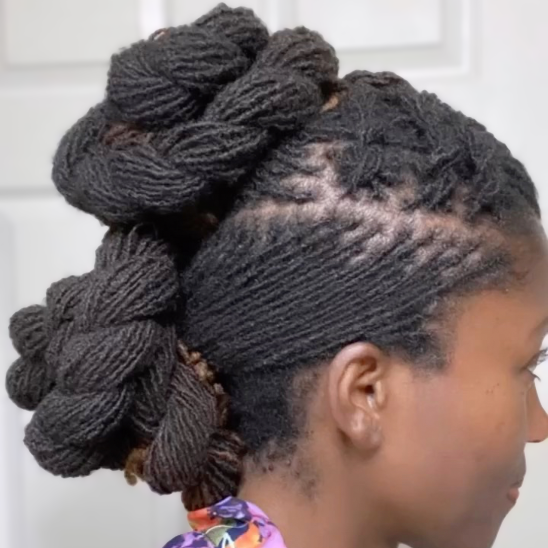 woman with microlocs and flat twists and twisted knot bun