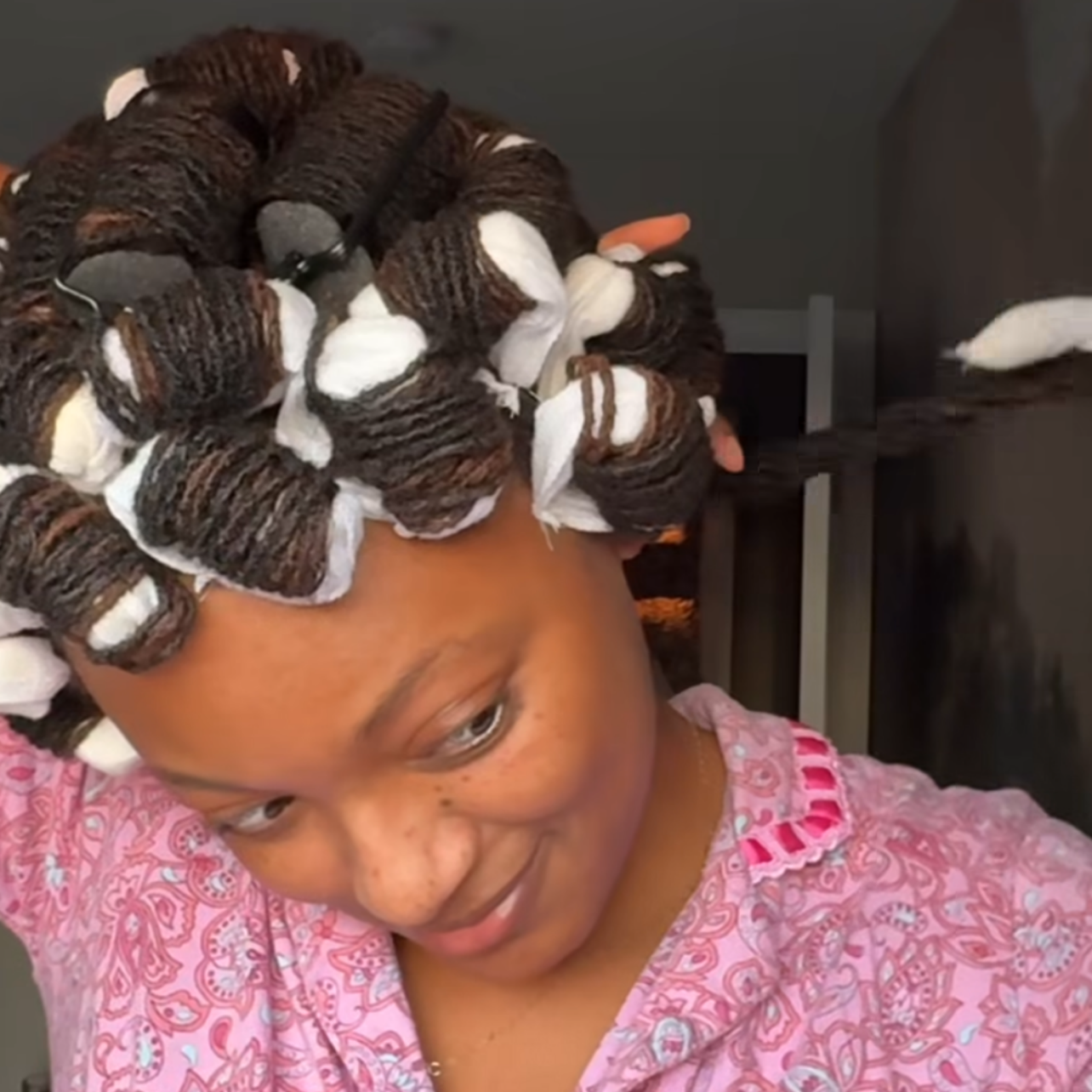 woman with microlocs and soft pillow rollers
