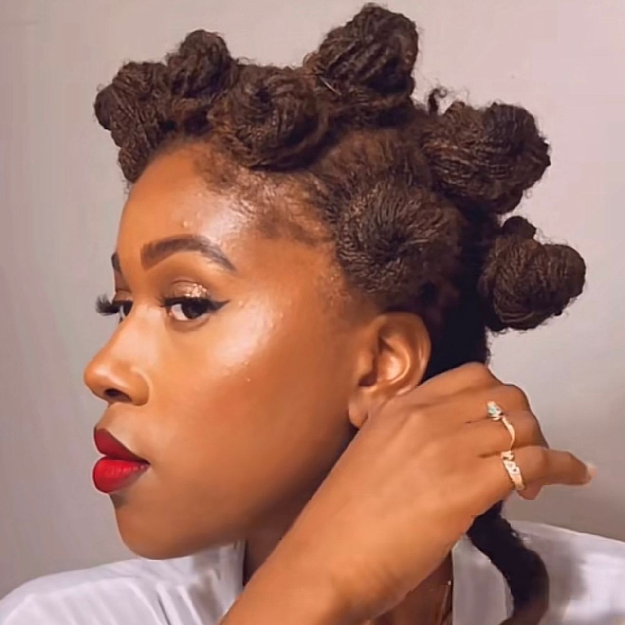 woman with microlocs and bantu knot curls