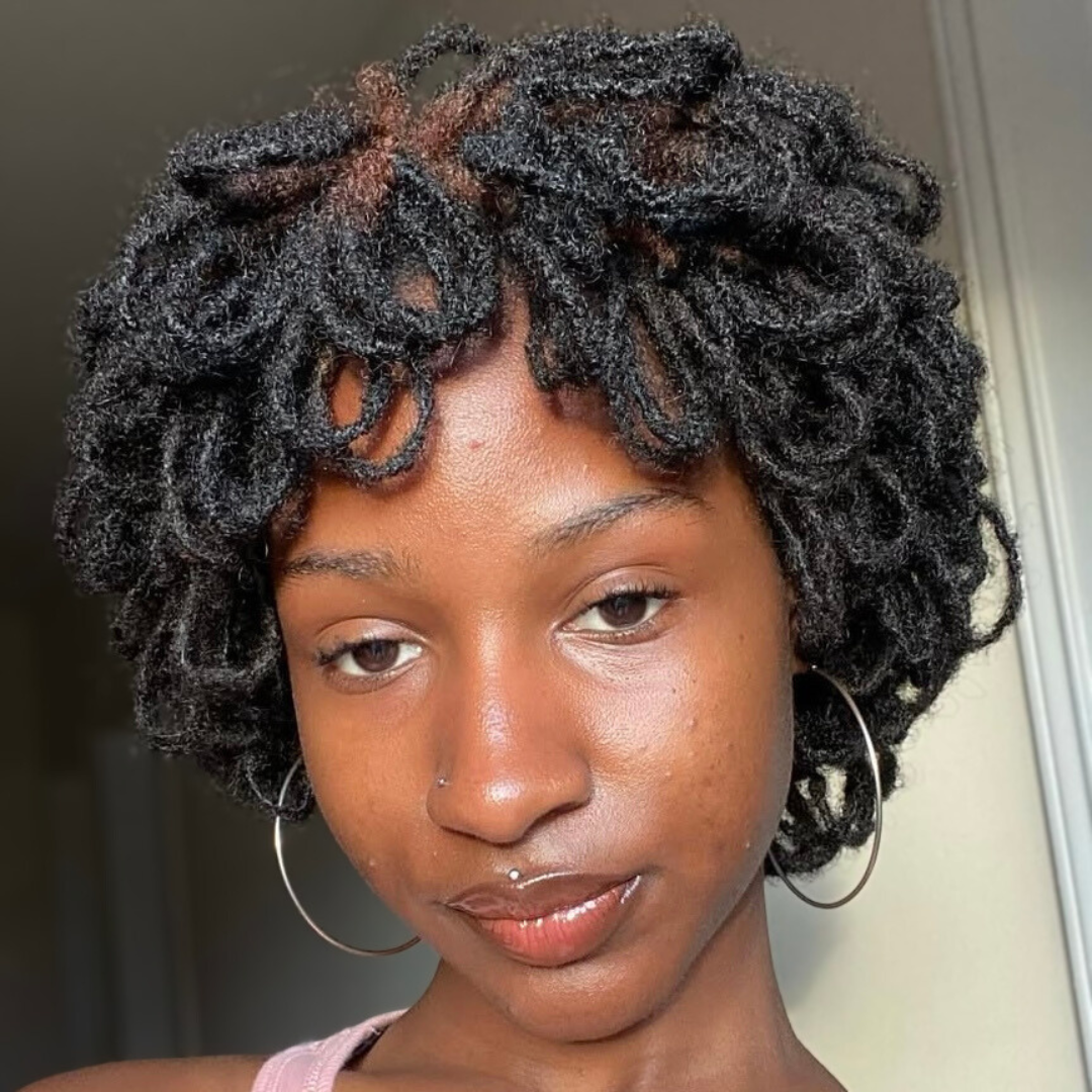 woman with microlocs and looped pin up updo