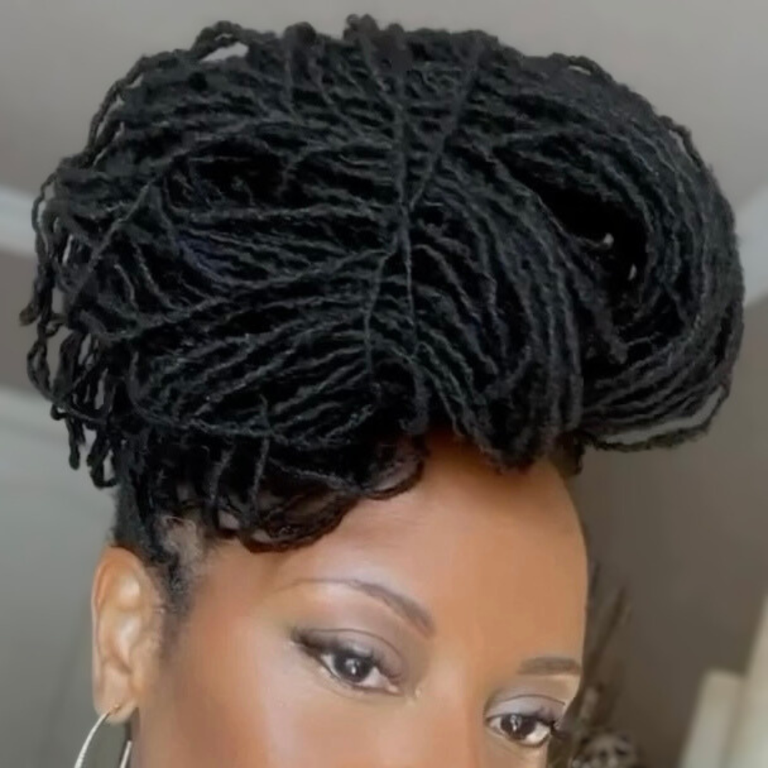 woman with microlocs and jumbo messy bun