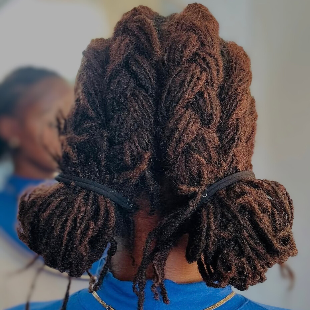 woman with microlocs and cornrow braids and buns