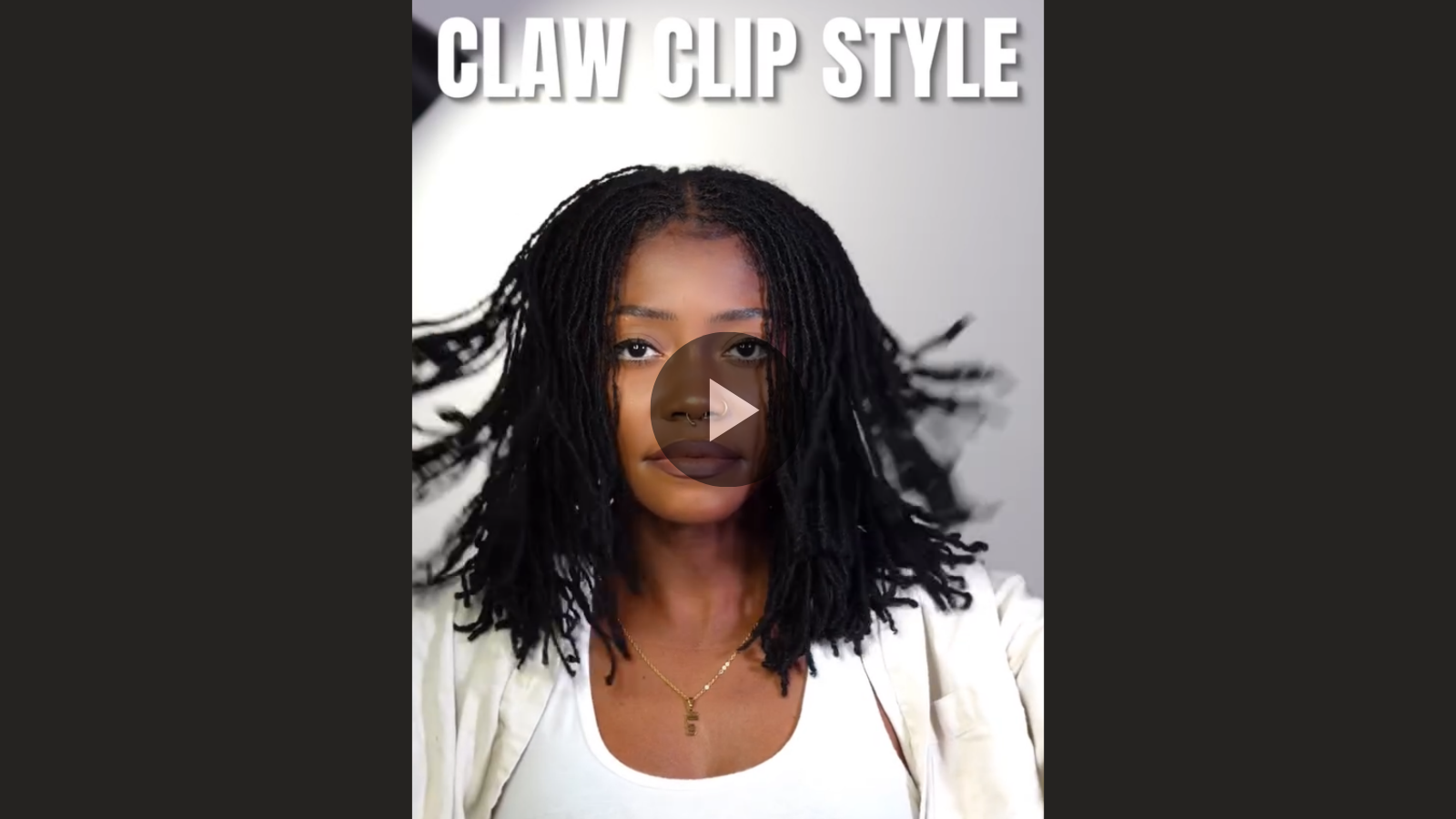 woman with microlocs and claw clip updo