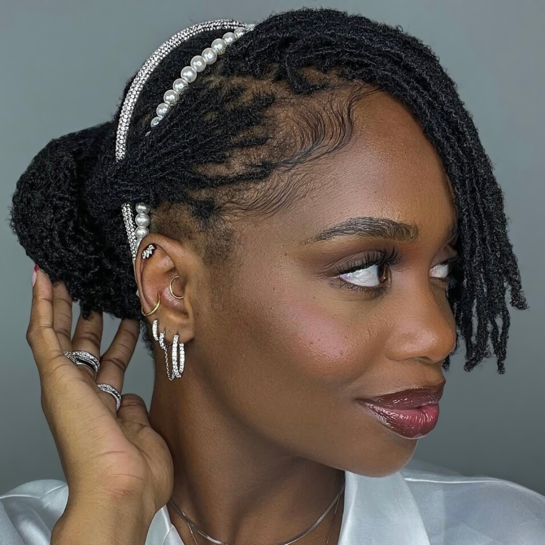 woman with microlocs and twisted bun with bangs