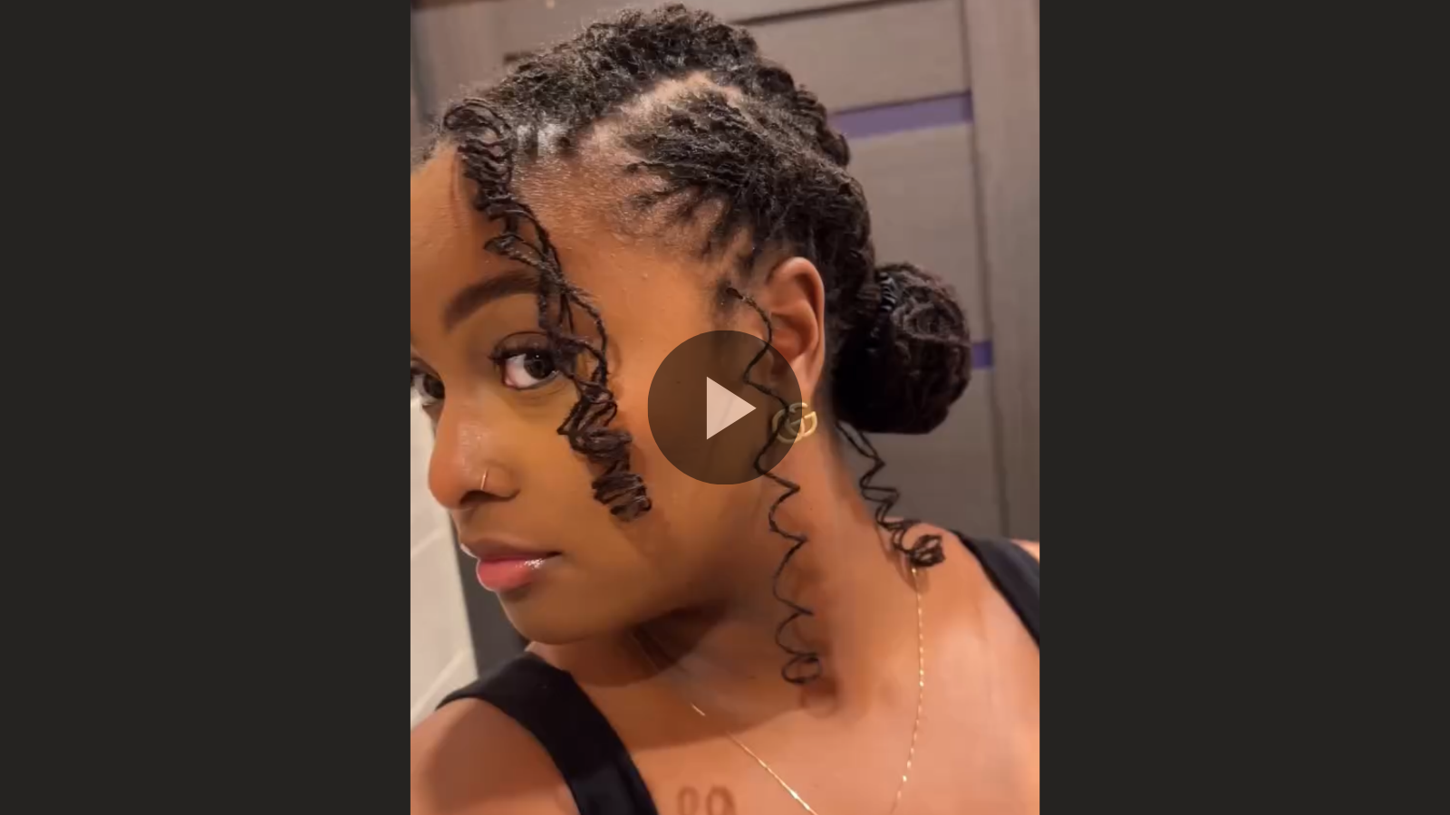 woman with microlocs and boho braid bun