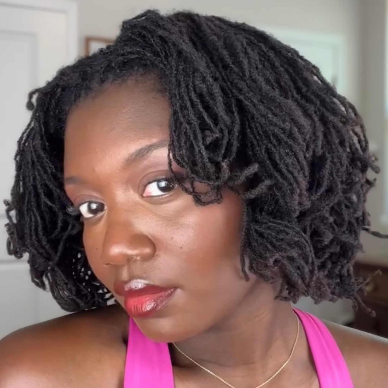 woman with microlocs and soft pillow roller curls