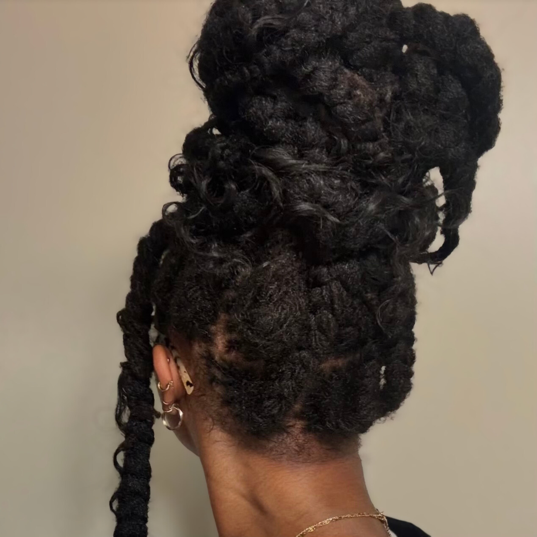 woman with microlocs and boho braid bun 
