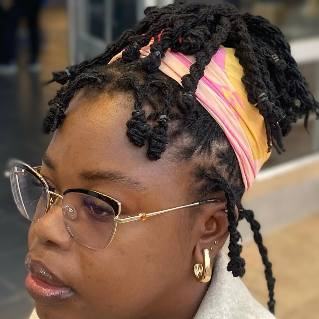 woman with microlocs and twisted locknot updo