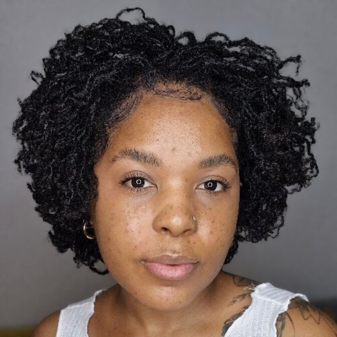 woman with microlocs and bantu knot curls