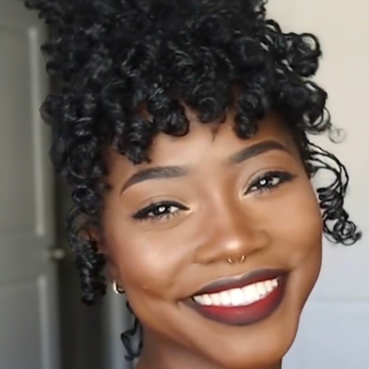 woman with microlocs and perm rod curls