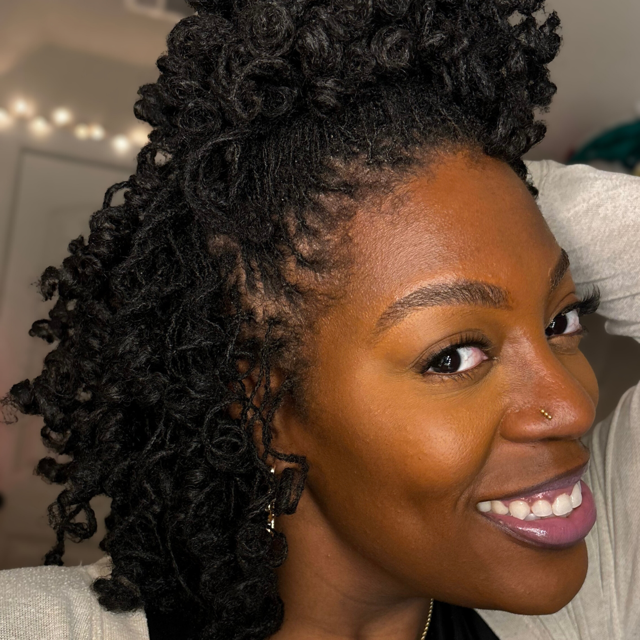 woman with microlocs and perm rod curls