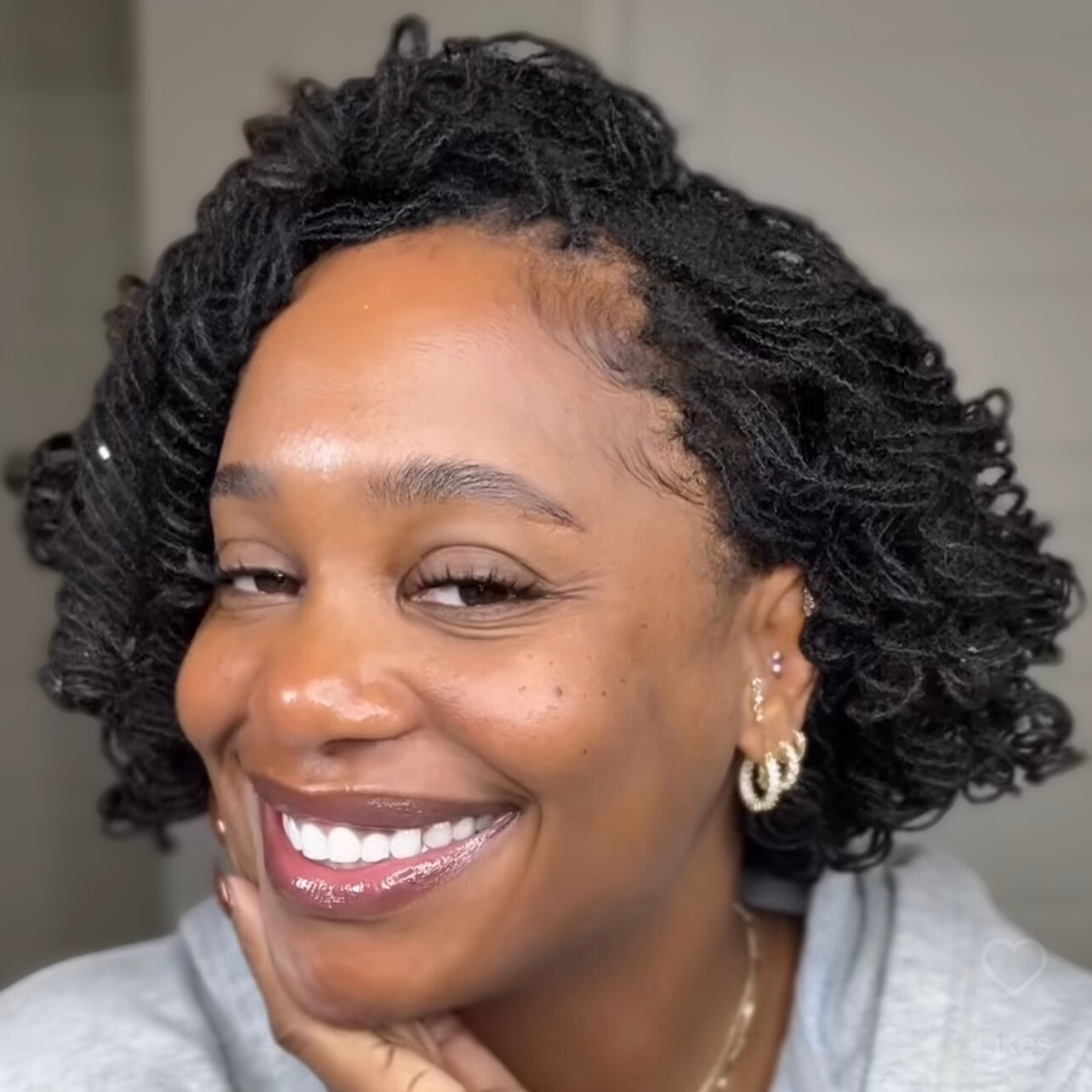 woman with microlocs and perm rod curls