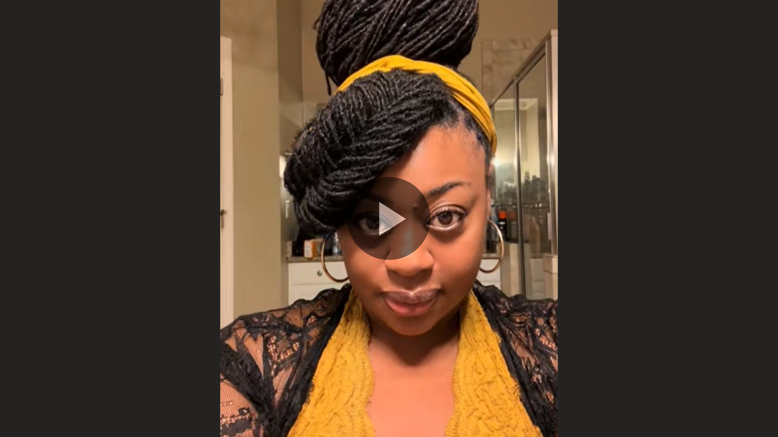 woman with long microlocs feathered bang and updo