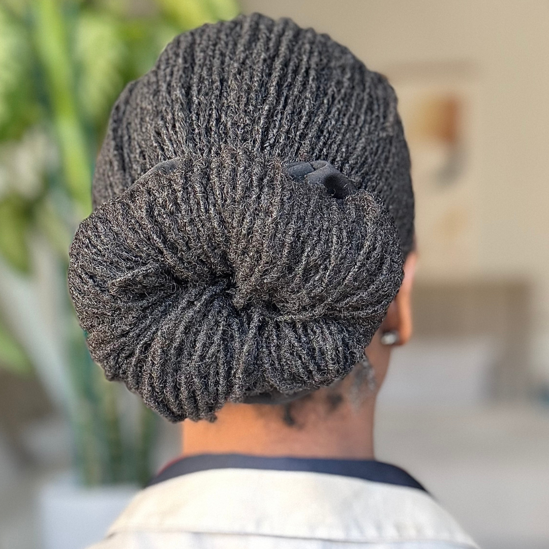 woman with beautiful microlocs bun on shoulder-length hair perfect hairstyle for work and professionals