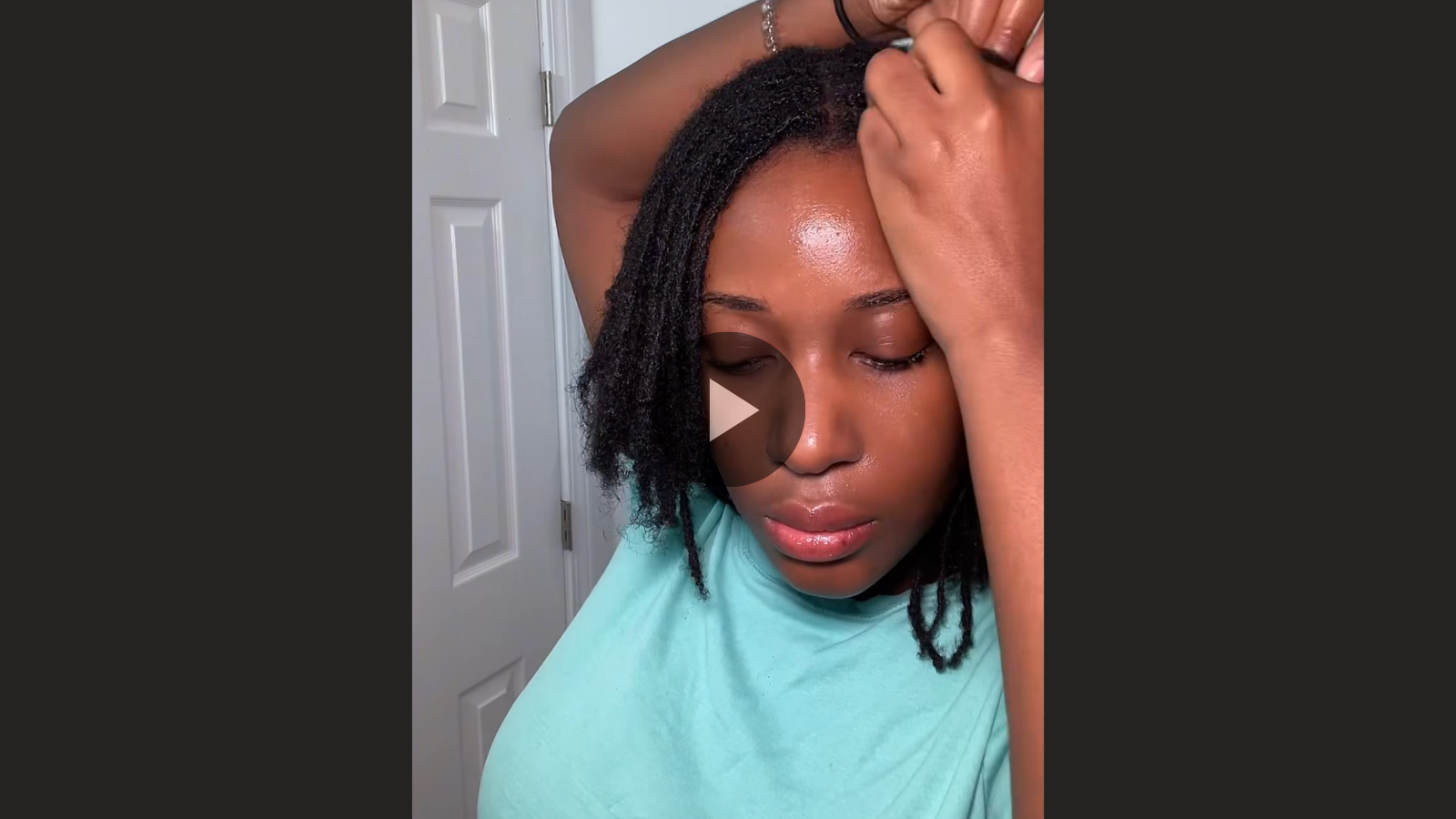 woman with microlocs and braided curly ponytail