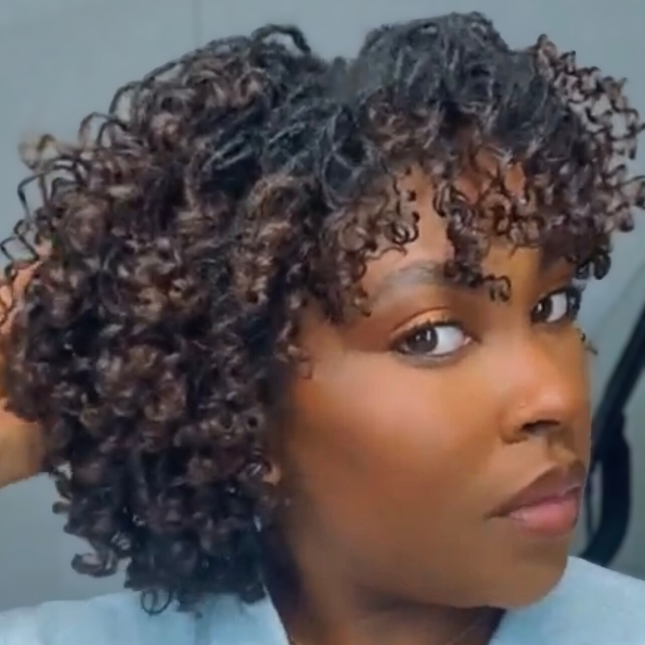 woman with microlocs and flexi rod curls
