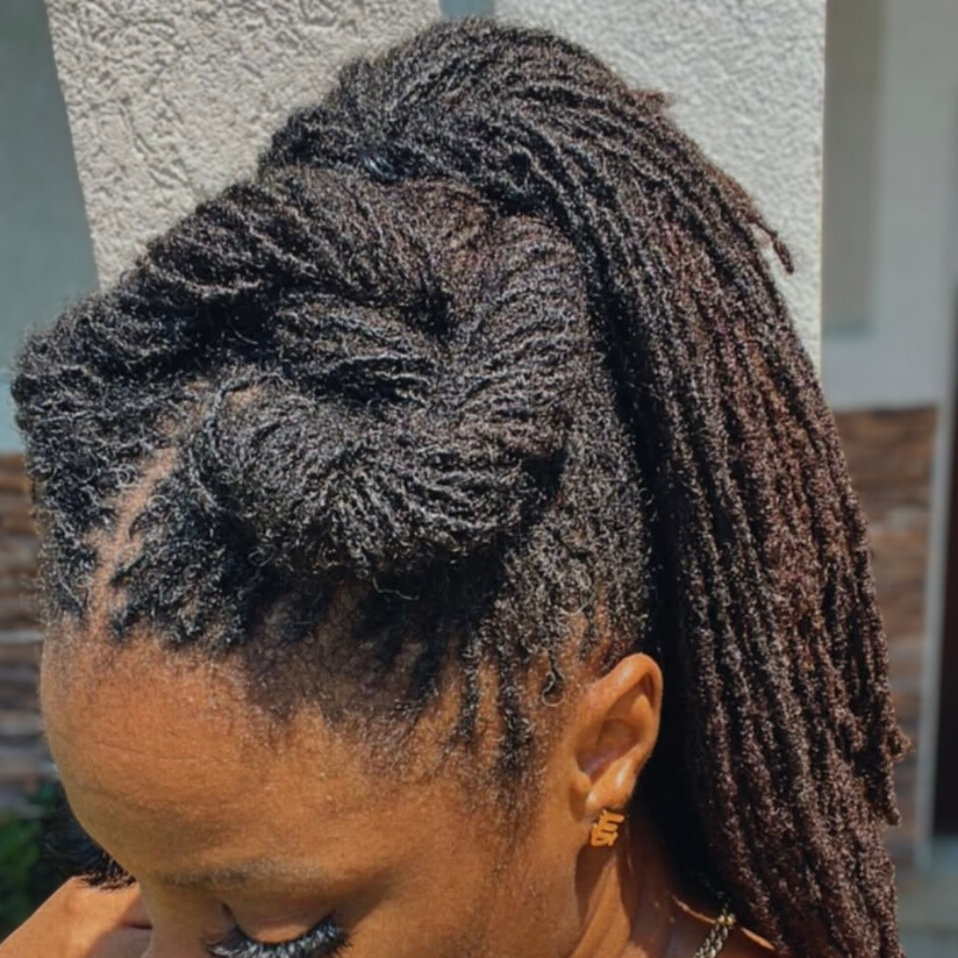 woman with microlocs and twisted half up hairstyle