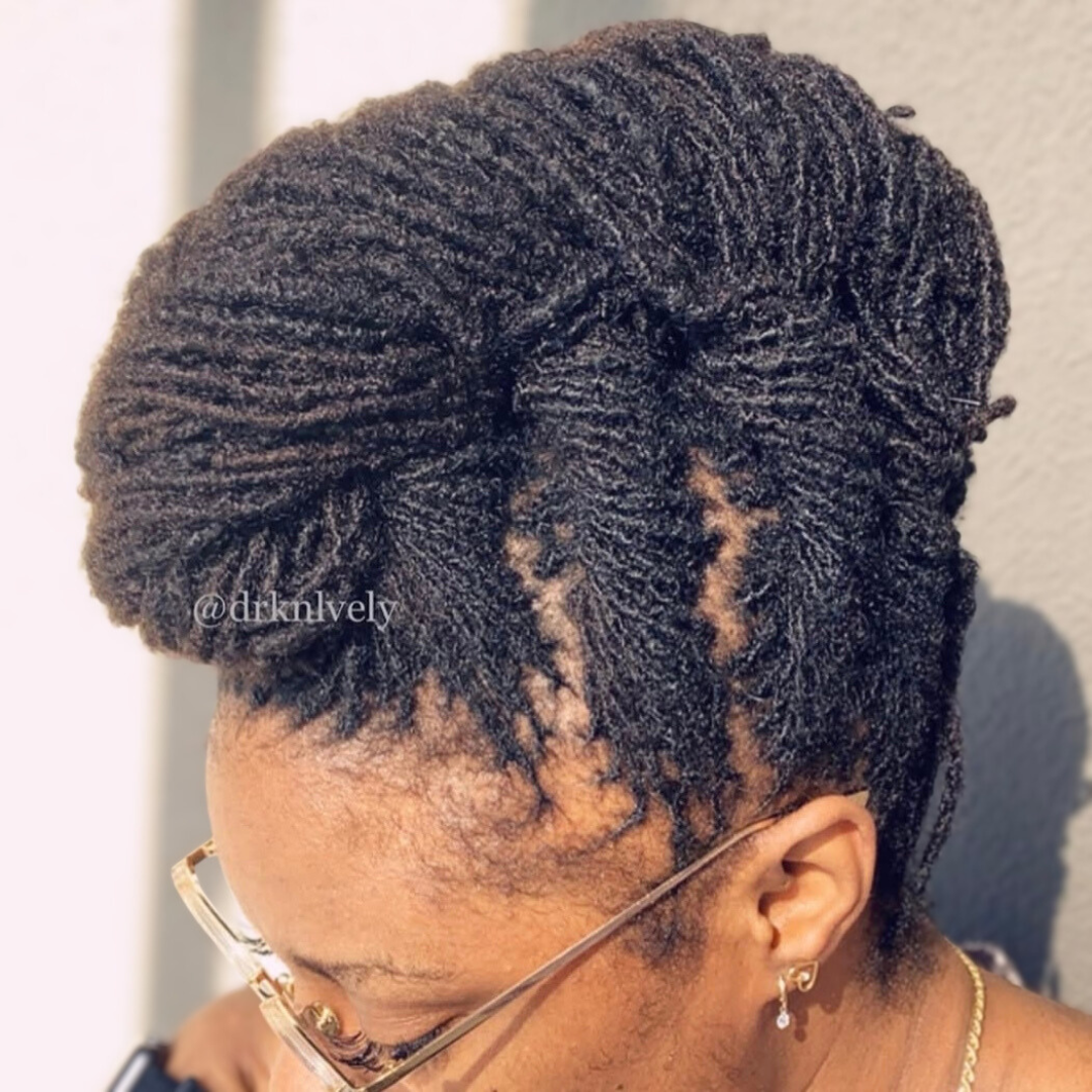 woman with microlocs and french twist up mohwark updo
