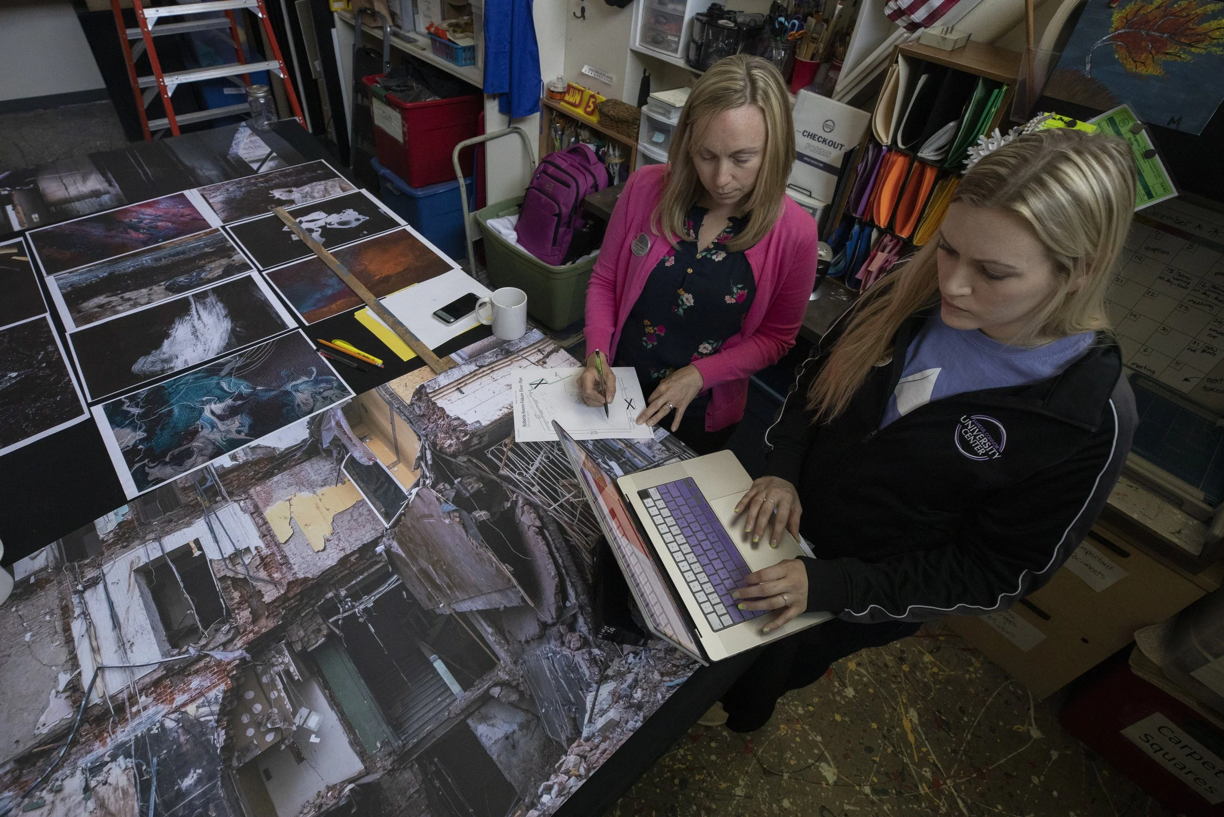 Veena Johnson planning a Roberta’s Art Gallery exhibition with a colleague