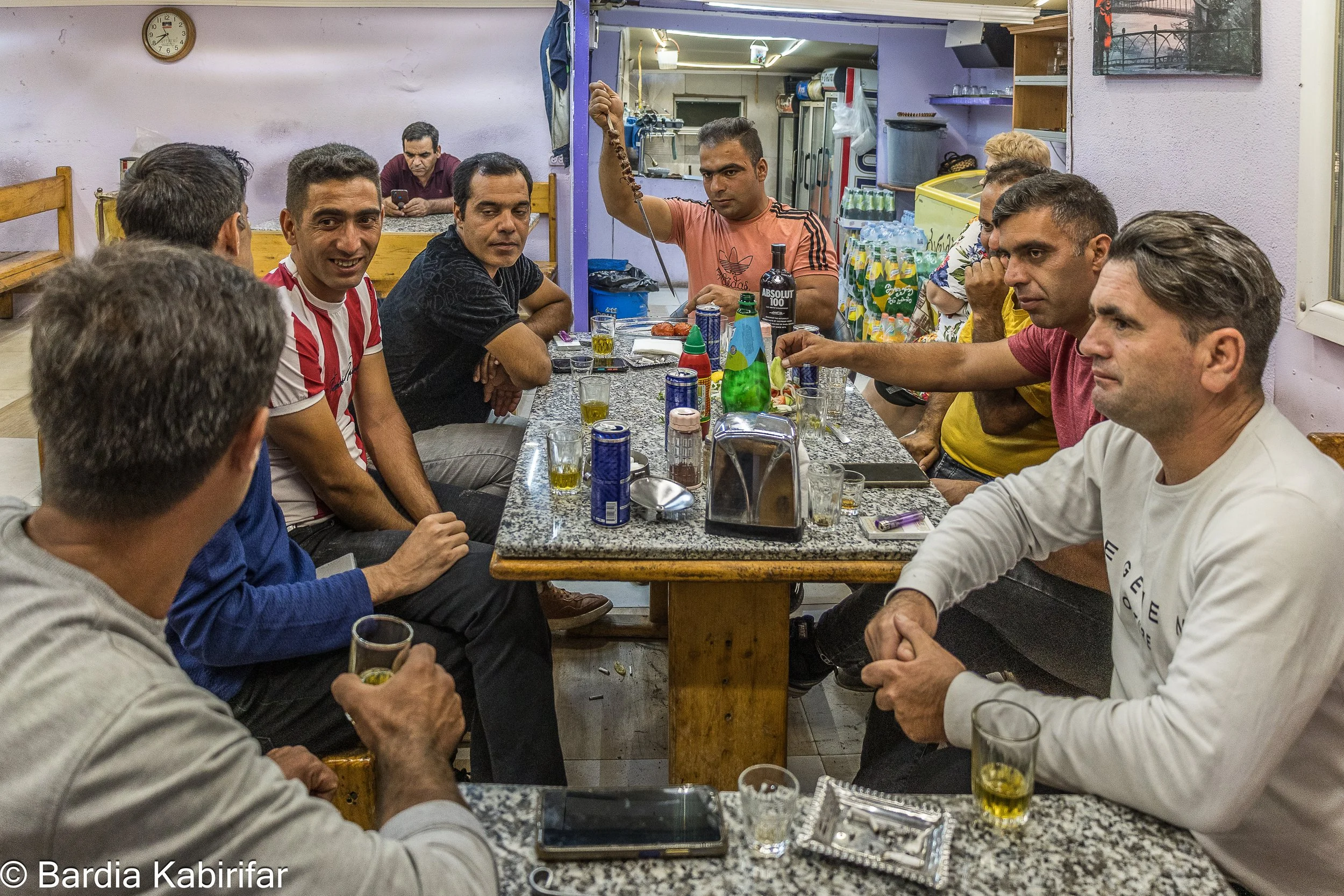 A group of Iranian truck drivers having beer and Kebab. This and other similar places help them feel more connected to their motherland while spending several weeks or months away from their families. (September 27th, 2023 Tbilisi, Georgia)