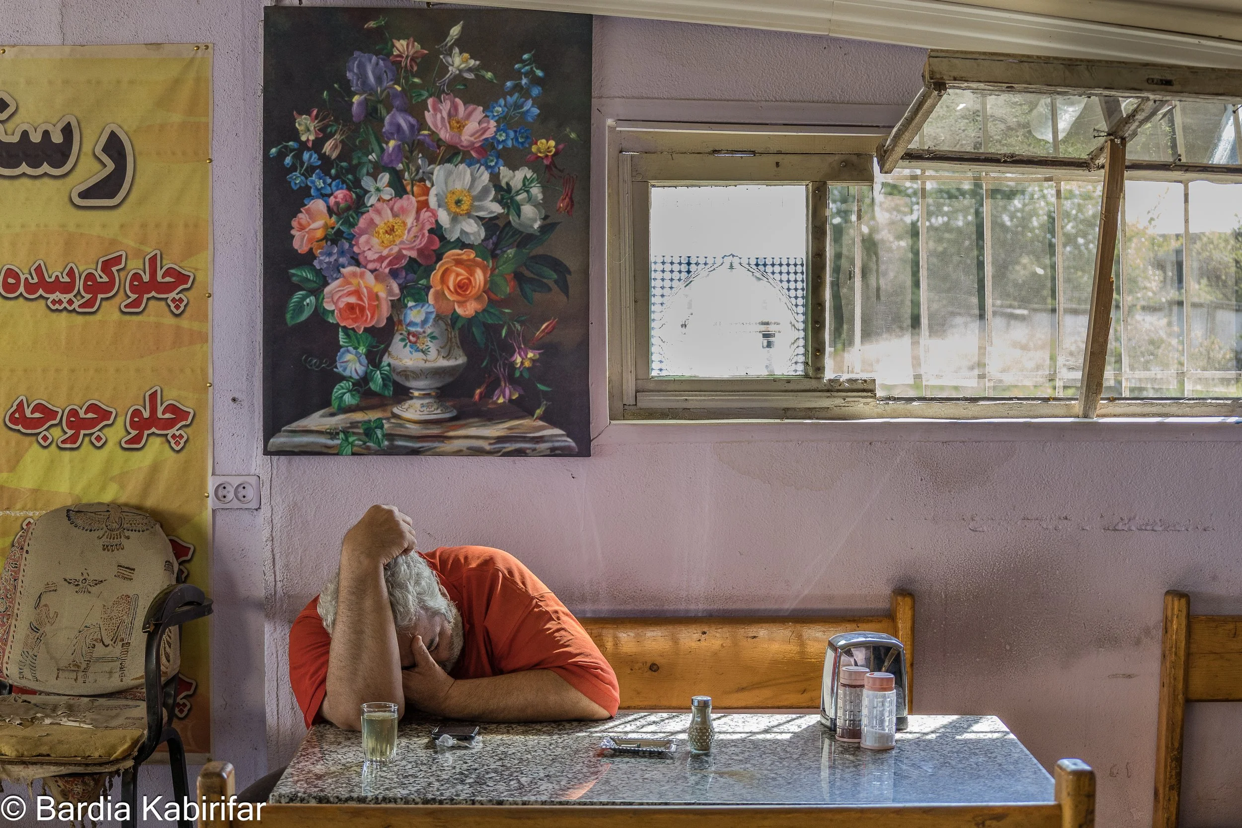 Gholamreza taking a nap in a small Iranian restaurant on the outskirts of Tbilisi while spending several days waiting for a new load of goods. "We've have never seen our children growing up" as said by many drivers. Despite all the challenges, many o