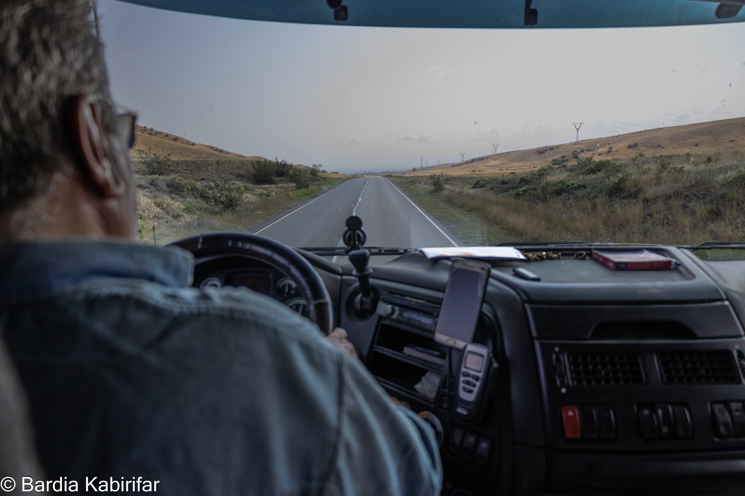 Ali drives towards Georgia-Azerbaijan border to deliver a load in Baku, Azerbaijan. Many of Iranian drivers who work in this region have hard time obtaining visas and passing borders. While this is a fundamental part of their job to travel to differe