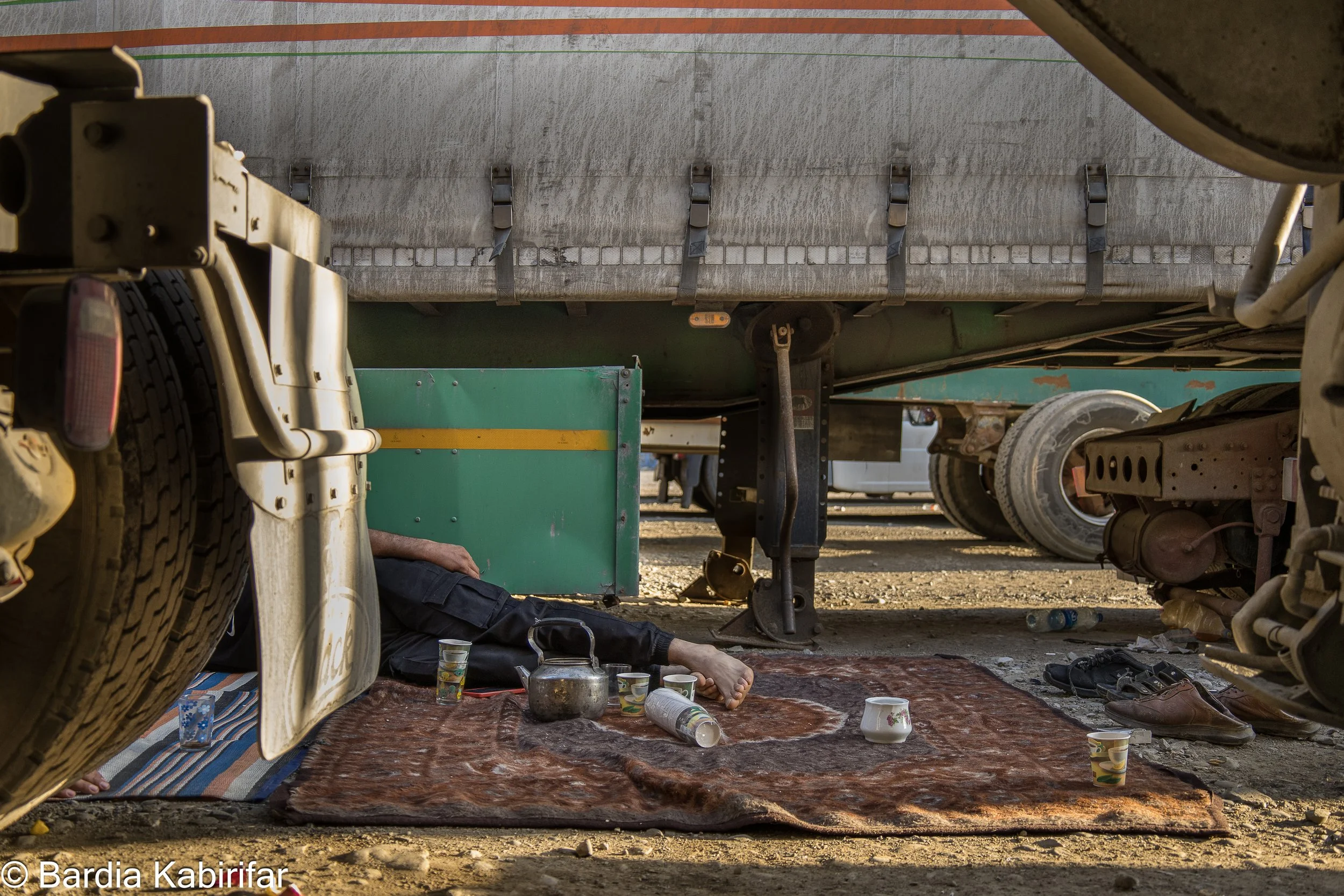 An Iranian trucker taking nap on a Persian carpet before returning to Iran on the following day. (September 27th, 2023 Tbilisi, Georgia)