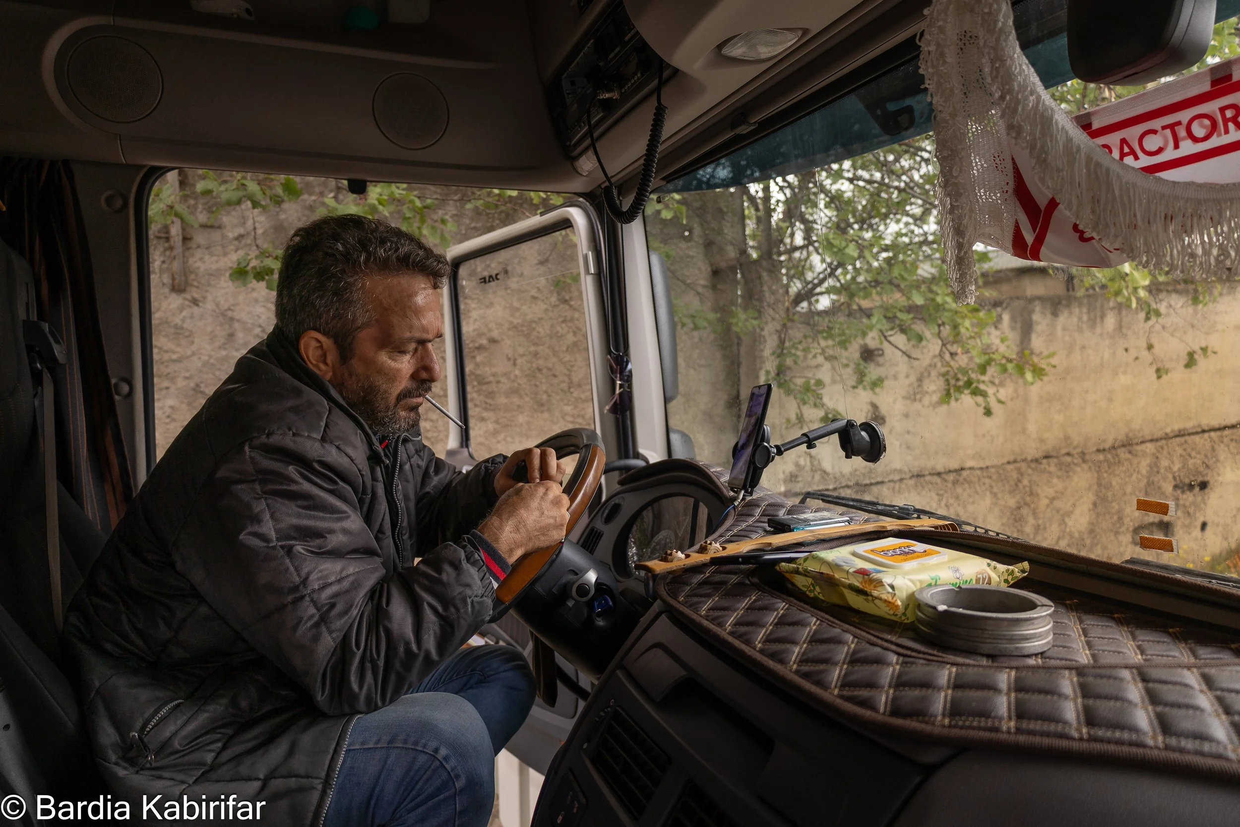 Akbar lights a cigarette while having a video call with his family in Iran. Sometimes, it gets quite formidable to manage family issues while being far from home for a long time. Fortunately, technology and social media helped drivers to have easier 