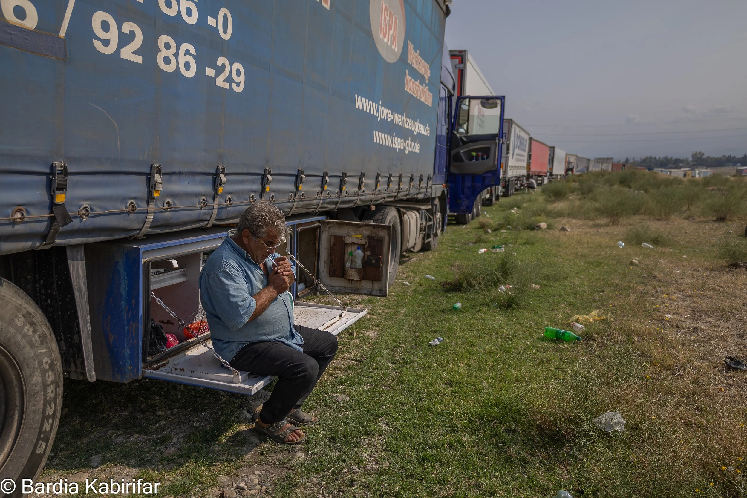 Ali spends long hours waiting for the line to move forward. It is not unusual for Ali, and other drivers, to spend 3 to 4 days at borders before he can enter the new country. On this long journey, his truck and a few personal belongings are the only 