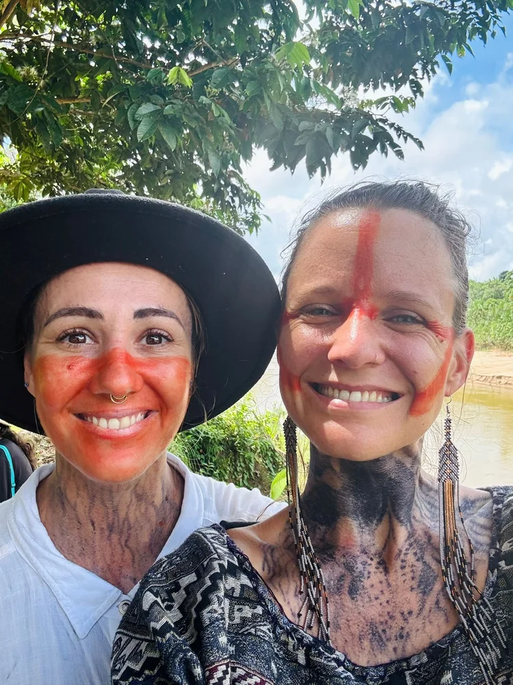 Two people smiling together in the rainforest