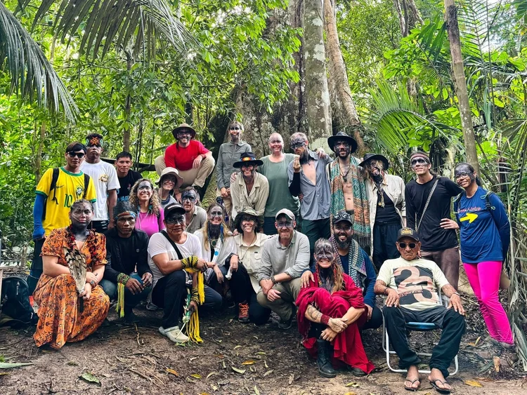 A group gathered in the rainforest on a past Munay journey