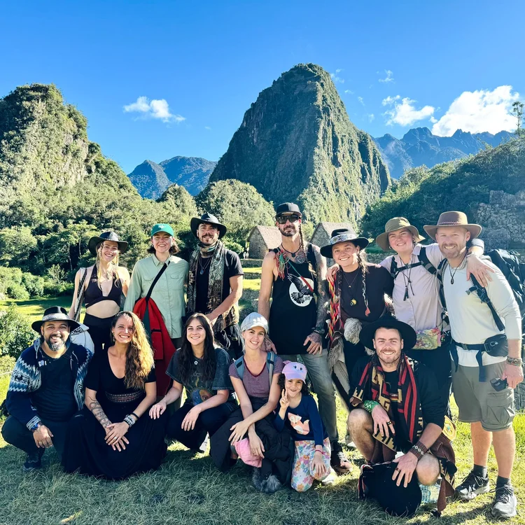 Retreat group in front of Machu Picchu and green mountains