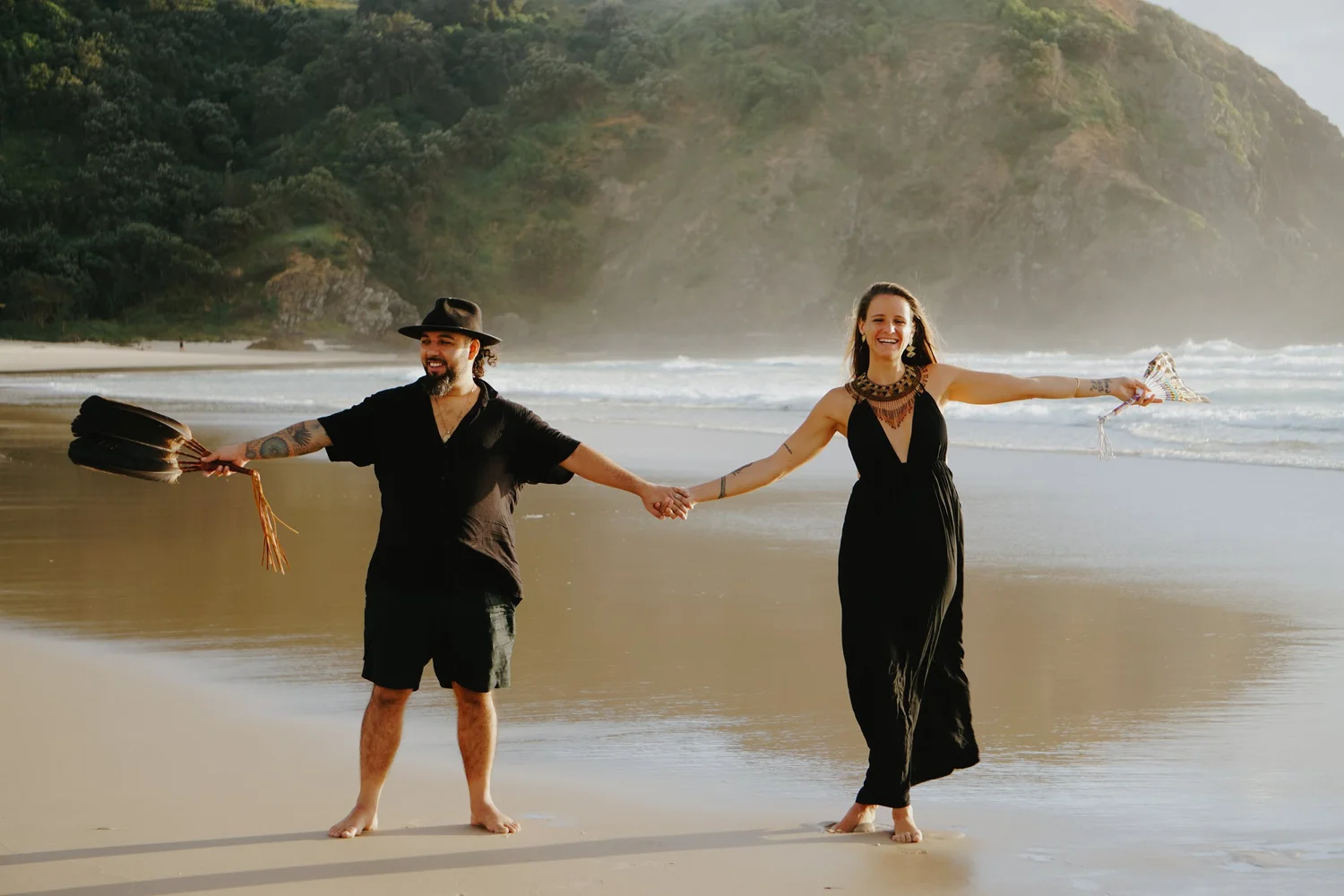 Omora and Sophie holding hands on the beach
