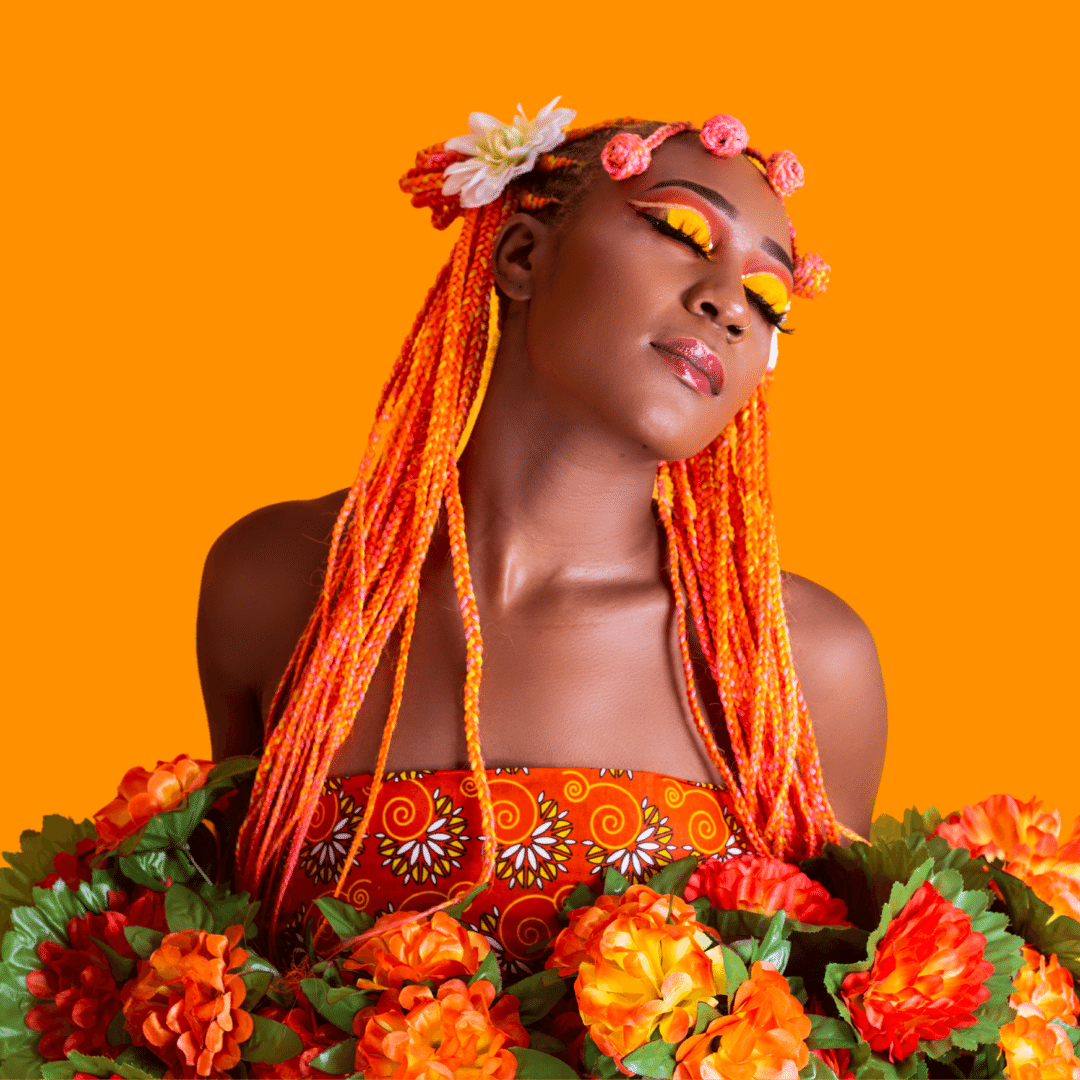 Black woman with orange braids and bright yellow eyeshadow