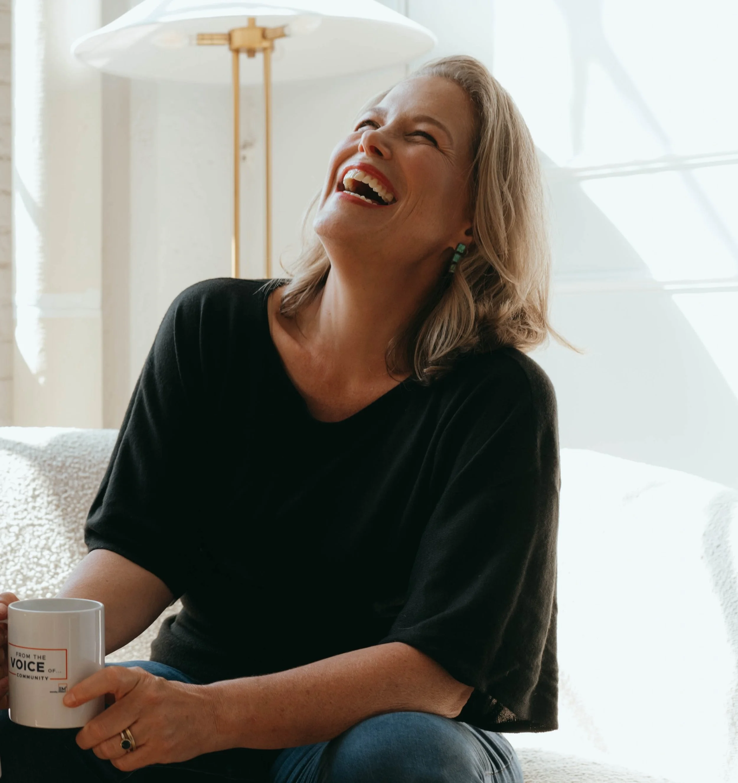 Woman in black sweater laughing